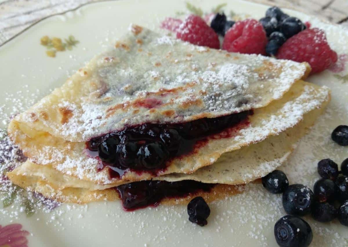 A close up of Wild Berries Crepe with some fruit on the right side