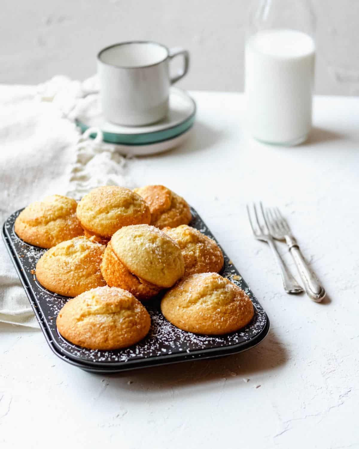 Coconut-Muffins-on-a-tins-with-2-on-top-milk-aside