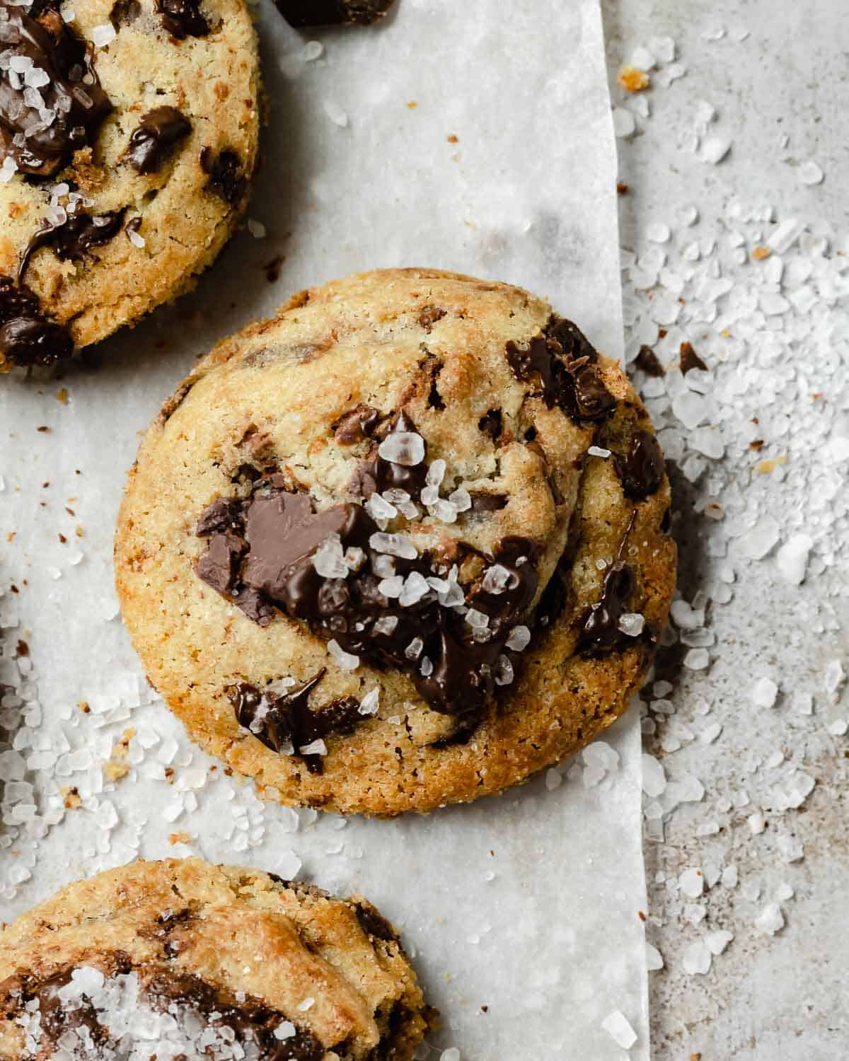 Three Chocolate Chip Cookies showing all the chocolate baked inside and topped with salt