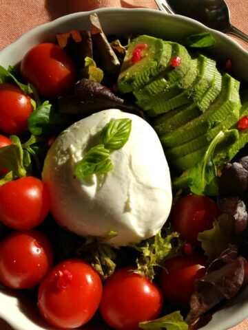 Mixed Leaf Salad with Burrata from above in a light orange linen