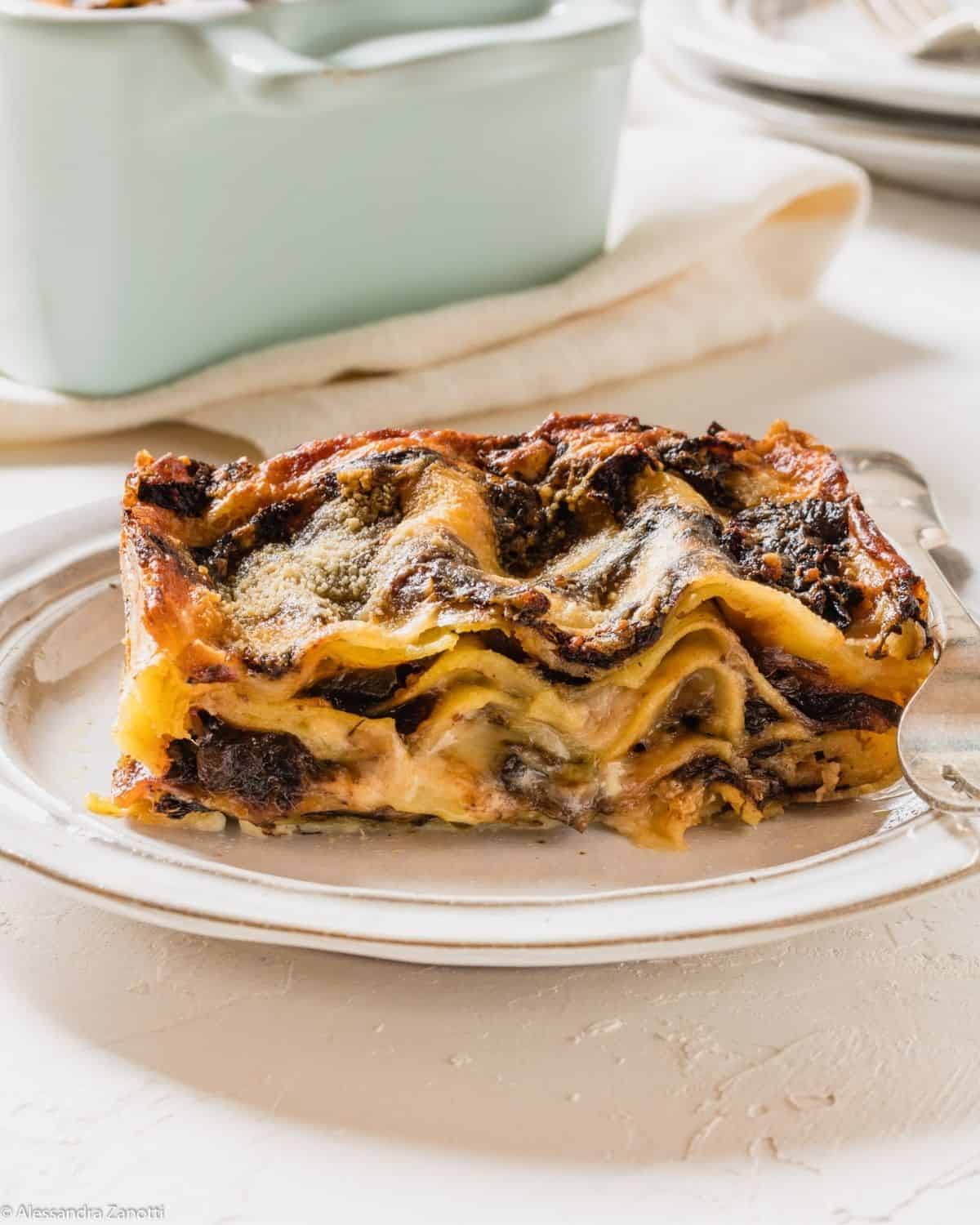 A slice Radicchio Lasagna showing all the layers with Besciamella and Radicchio