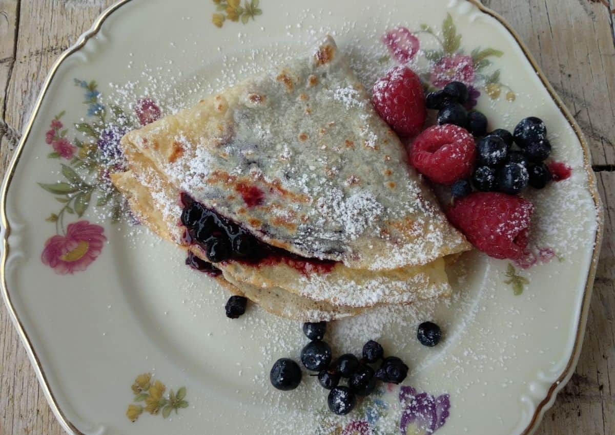 A close up from above of Wild Berries Crepe with some fruit on the right side