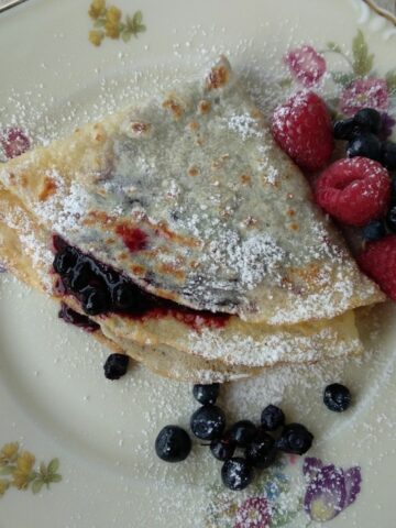 A close up of Wild Berries Crepe with some fruit on the right side